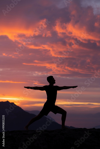 A photo of a silhouette of a man doing yoga on a mountain top at sunset.