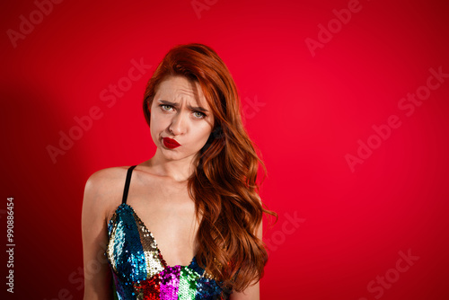 Wallpaper Mural Portrait of stunning young girl sullen face empty space glossy dress isolated on vibrant red color background Torontodigital.ca