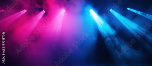 Colorful Stage Lights with Pink and Blue Beams Shining Through Smoke in a Dark Atmosphere