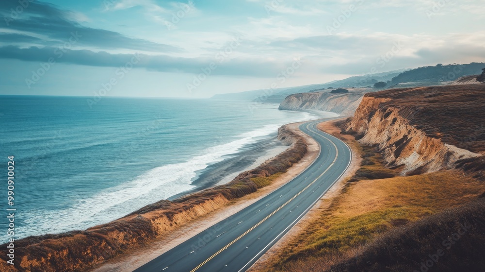 Empty coastal highway hugging the shoreline, with the ocean to one side and cliffs on the other Empty coastal highway hugging the shoreline, with the ocean to one side and cliffs on the other