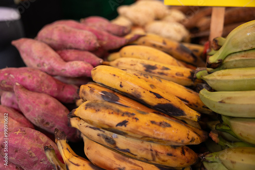 Close-up of bananas and sweet potatoes at a market stall on the Haagse Market in The Hague, Netherlands. Fruits and vegetable.