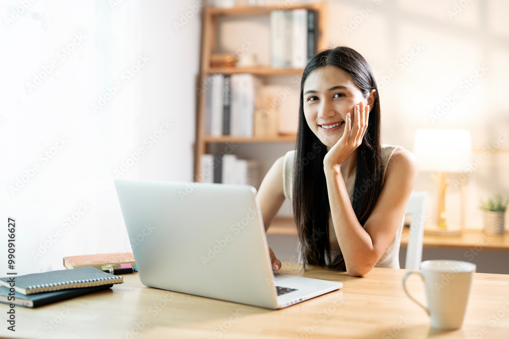 Smiling confident businesswoman looking at camera sitting at home office desk. Smiling confident businesswoman looking at camera sitting at home office desk.