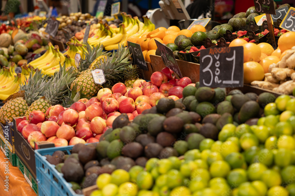 The Hague, Netherlands - July 9, 2004: Close-up of apples surrounded by other types of fruit such as pineapples, bananas, avocados and lemons. Haagse Market in The Hague, Netherlands. The Hague, Netherlands - July 9, 2004: Close-up of apples surrounded by other types of fruit such as pineapples, bananas, avocados and lemons. Haagse Market in The Hague, Netherlands.