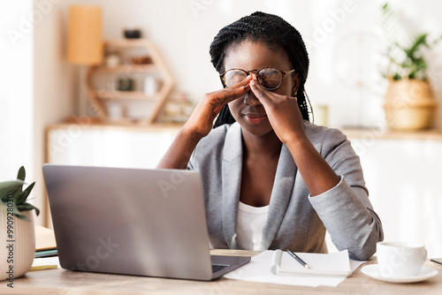 Eye Strain. Overworked Black Businesswoman Massaging Nosebridge At Workplace Having Eyesight Problem, Selective Focus photo