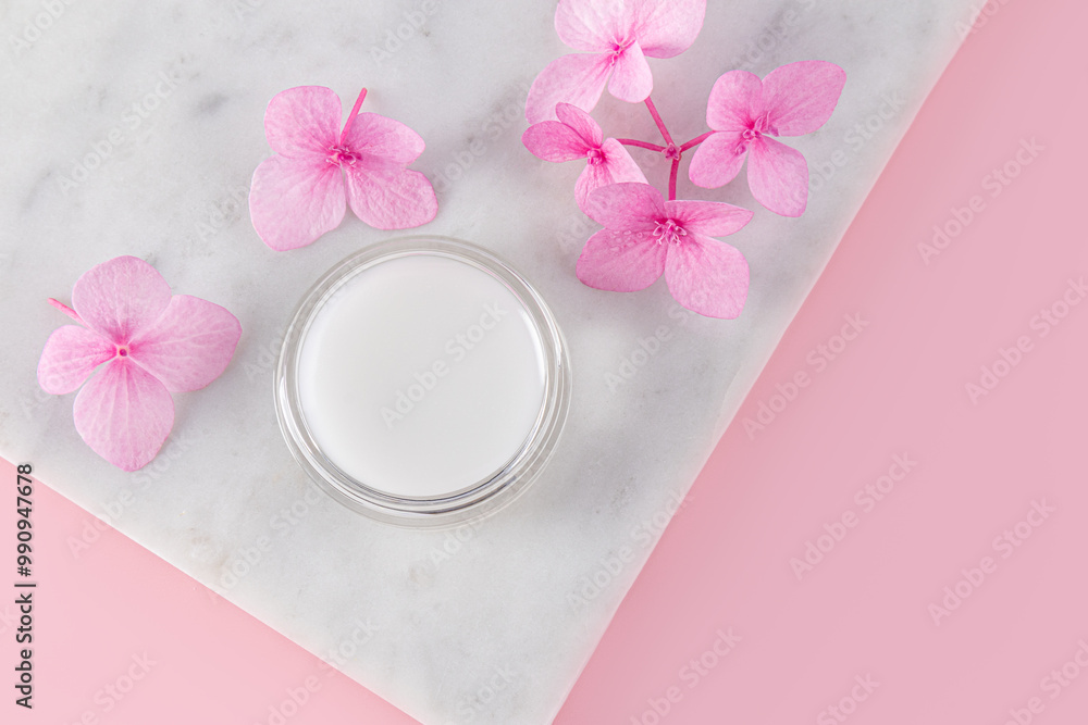 Cosmetic jar with natural colorless lip balm on a marble flower podium. pleasant aroma. Perfect for makeup. top view. copy space. Care, beauty concept Cosmetic jar with natural colorless lip balm on a marble flower podium. pleasant aroma. Perfect for makeup. top view. copy space. Care, beauty concept