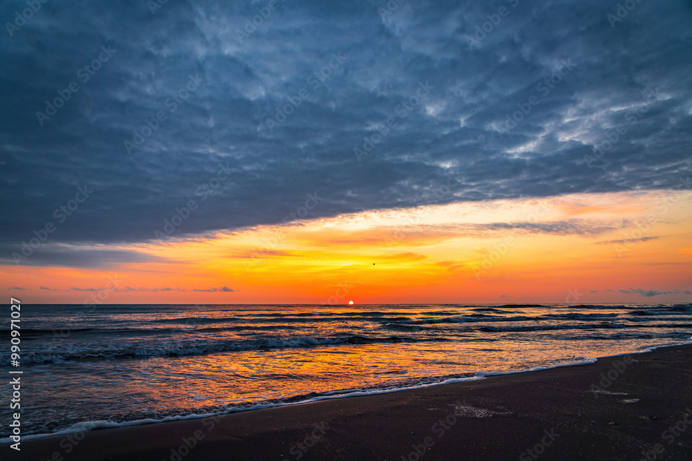 Fototapeta premium Colorful sunrise on the sea sandy beach
