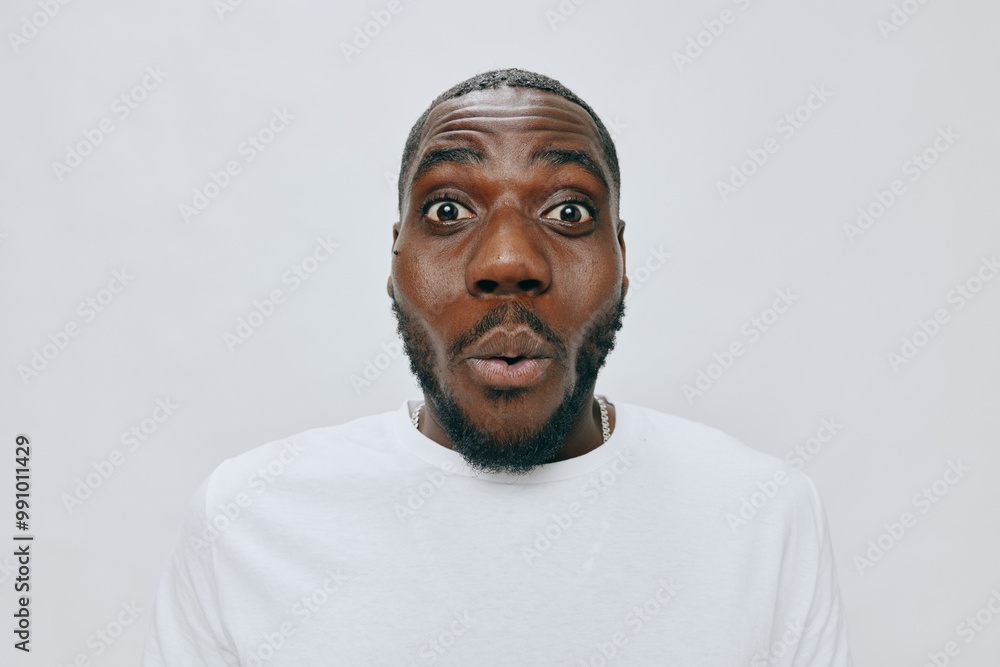 surprised expression, male model, dark skin, white shirt, neutral background, joyful, excitement, reaction, facial emotion, candid shot, studio photography, portrait lighting, amazement surprised expression, male model, dark skin, white shirt, neutral background, joyful, excitement, reaction, facial emotion, candid shot, studio photography, portrait lighting, amazement
