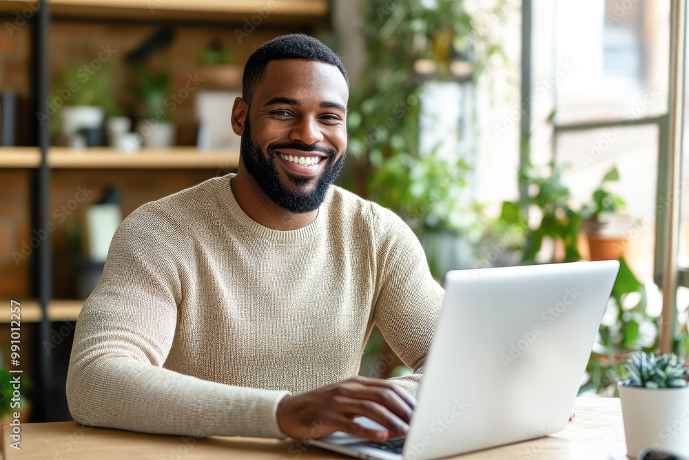 Individual typing on a laptop in a cozy, plant-filled workspace with natural light coming through the window beside them. Individual typing on a laptop in a cozy, plant-filled workspace with natural light coming through the window beside them.