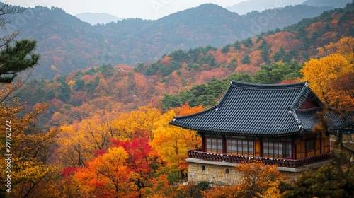 Yongmunsa Temple, known for its tile house, is nestled amidst vibrant autumn foliage on Yongmunsan Mountain in Yecheon-gun, South Korea. photo