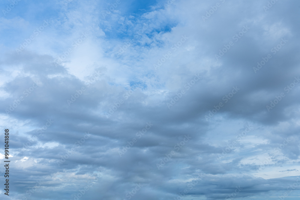 Dramatic cloudscape of white fluffy clouds against a vibrant blue sky Dramatic cloudscape of white fluffy clouds against a vibrant blue sky