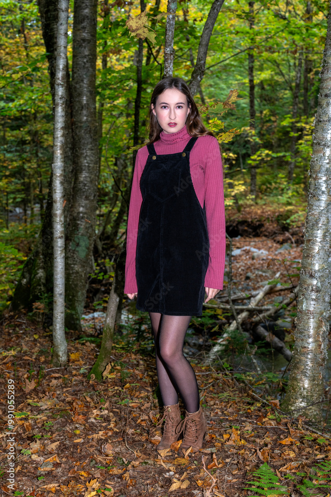 A young woman walking in the fall colors A young woman walking in the fall colors