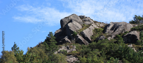 Rock formation in Egersund surrounded by forest, Norway. photo