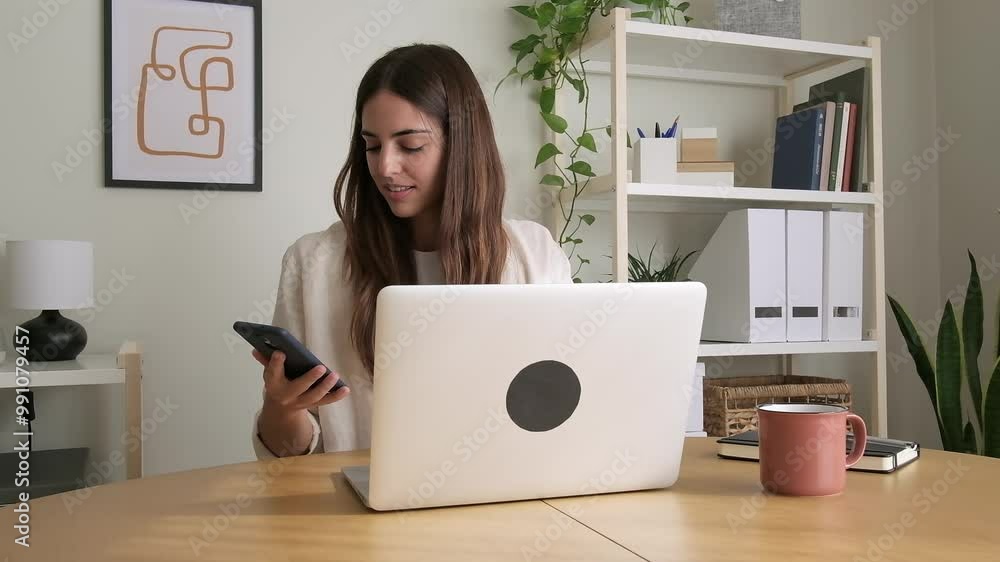 Woman talking on the phone while working at home office using laptop. HD video. Woman talking on the phone while working at home office using laptop. HD video.
