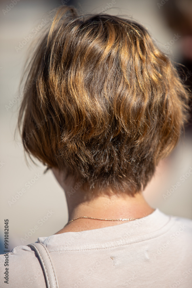 A woman with brown hair and a necklace A woman with brown hair and a necklace