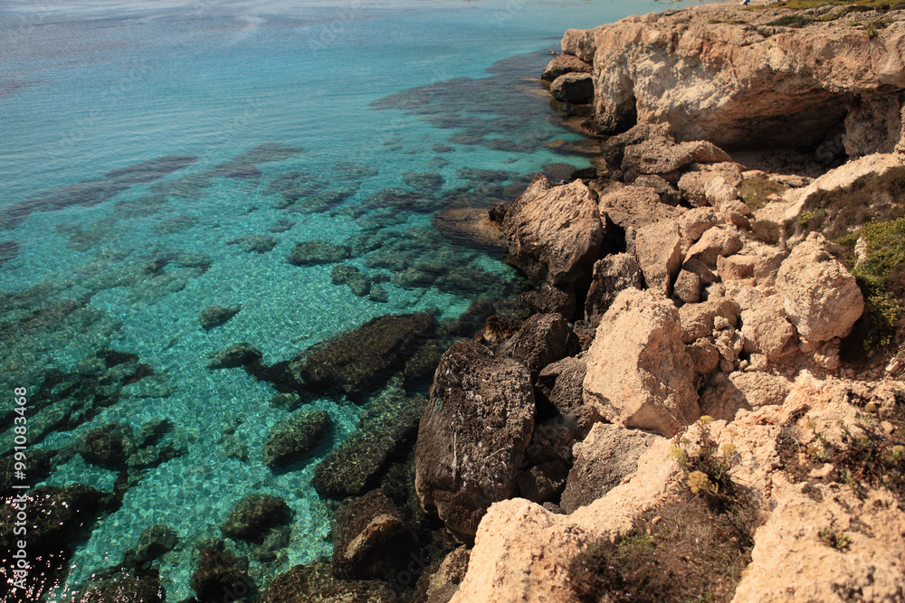 Crystal clear water and rugged coastline at a Cypriot beach during a sunny afternoon in the Mediterranean Crystal clear water and rugged coastline at a Cypriot beach during a sunny afternoon in the Mediterranean