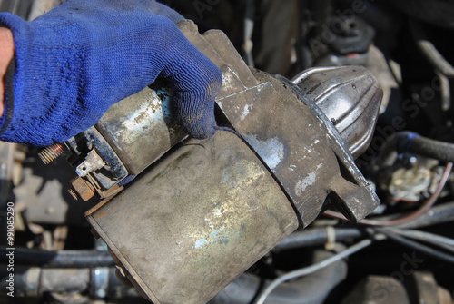 Картината върху платно car starter in mechanic's hand close-up