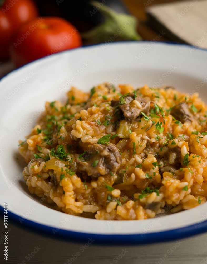 Rice paella with Iberian pork cheek. Traditional spanish tapa with iberic pork. Rice paella with Iberian pork cheek. Traditional spanish tapa with iberic pork.