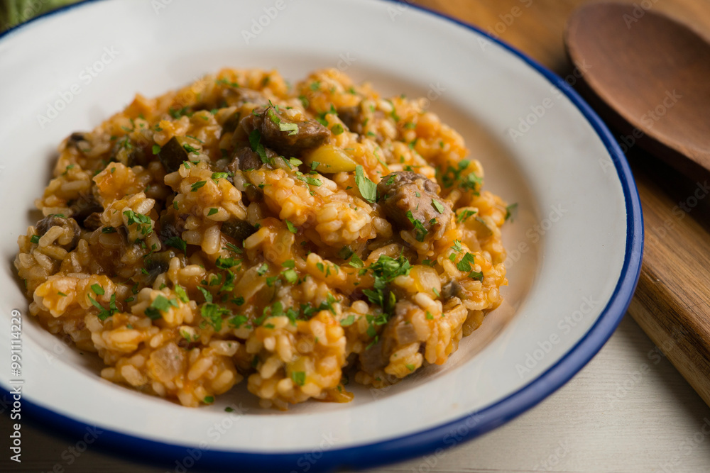 Rice paella with Iberian pork cheek. Traditional spanish tapa with iberic pork. Rice paella with Iberian pork cheek. Traditional spanish tapa with iberic pork.