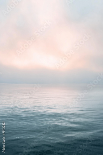 Serene Seascape at Dawn: A minimalist vista of a tranquil ocean, bathed in the soft, ethereal glow of sunrise, evokes a sense of peace and calm. The horizon blends seamlessly with the sky.