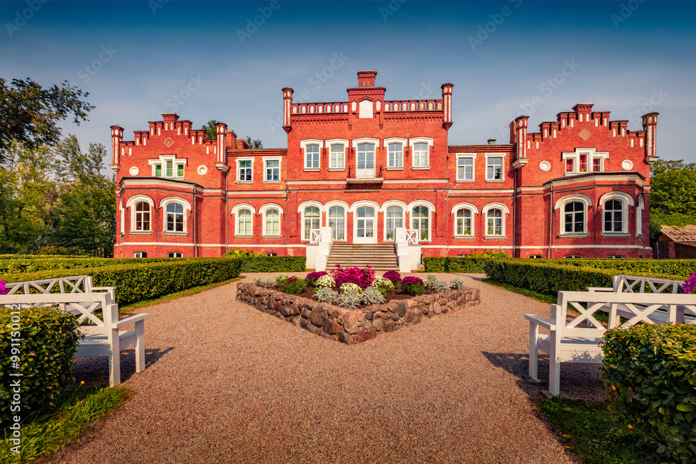 Naklejka premium Stunning morning view of old red brick Mezmuiza castle, Latvia, Europe. Colorful summer scene of Augstkalne village, Dobele Municipality, Latvia, Europe. Traveling concept background.