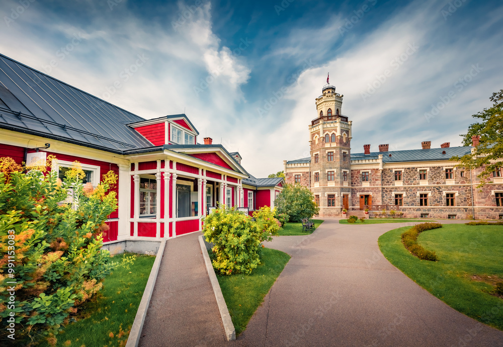 Sunny morning view of Sigulda New Castle with green meadow and empty tourist path . Impressive summer cityscape Sigulda town, Siguldas novads, Latvia, Europe. Traveling concept background.