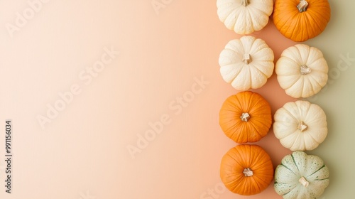 Row of pumpkins on a peach and green background evokes autumn vibes, perfect for seasonal decor or holiday projects. Top view highlights their vibrant colors photo