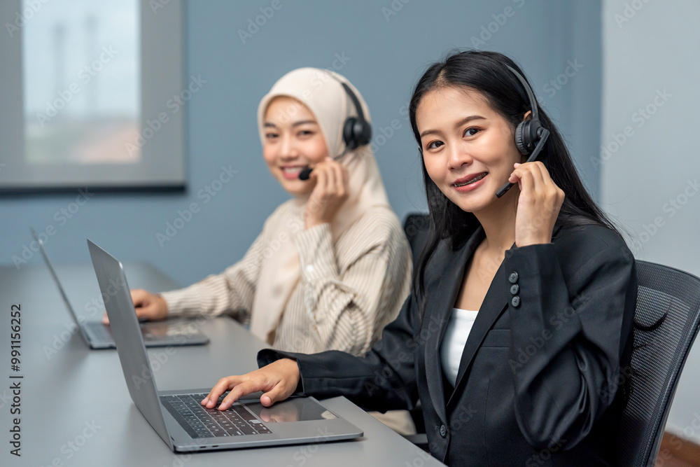 portrait a young smiling woman wears headset using laptop,working in call center service,talking with client,concept of telemarketing,customer relationship management(CRM) portrait a young smiling woman wears headset using laptop,working in call center service,talking with client,concept of telemarketing,customer relationship management(CRM)
