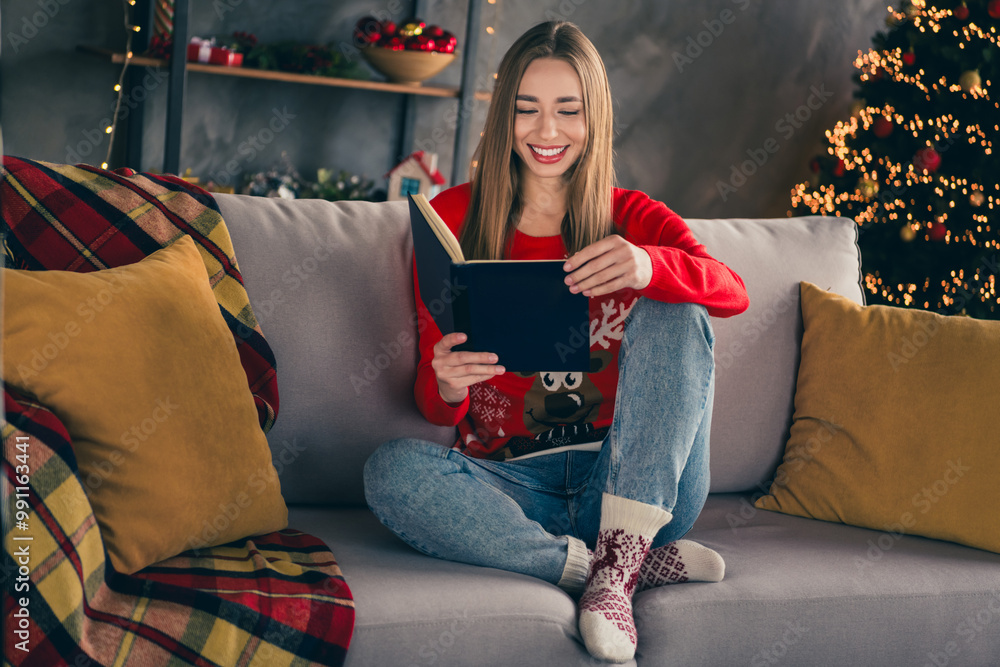 Full length photo of lovely cheerful girl sit sofa read book wear red christmas garment tradition atmosphere decor vibe house indoors room Full length photo of lovely cheerful girl sit sofa read book wear red christmas garment tradition atmosphere decor vibe house indoors room