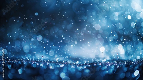 Raindrops fall to the ground, creating ripples and circles in blue