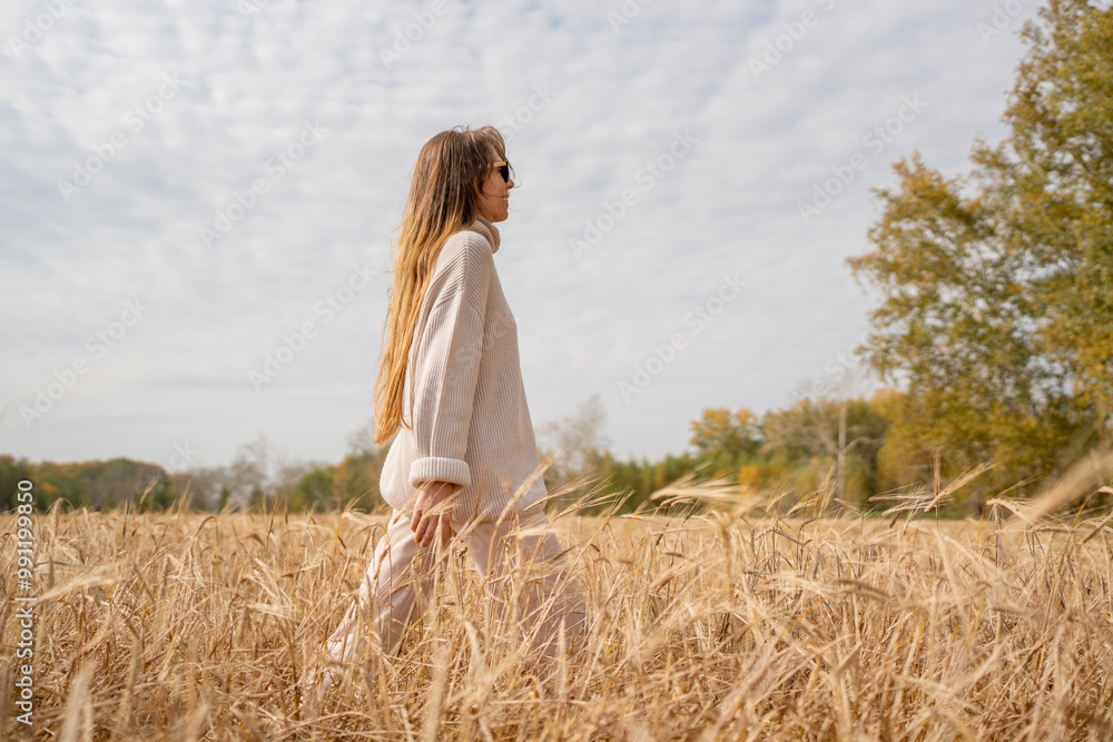 A Stylish Woman is Enjoying a Beautiful Sunny Day in the Middle of a Wheat Field A Stylish Woman is Enjoying a Beautiful Sunny Day in the Middle of a Wheat Field