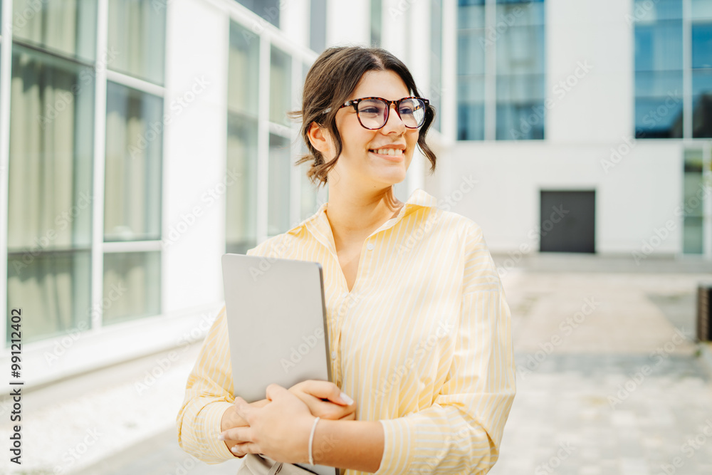 Young successful woman is going to work at modern business building Young successful woman is going to work at modern business building