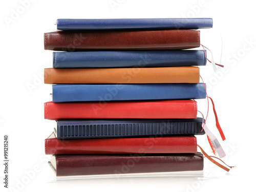 Stack of diaries or books with colorful covers on white background