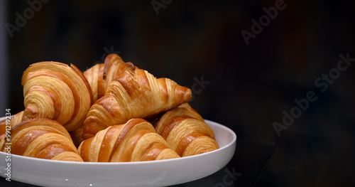 Homemade mini croissants on white plate in buffet line. Fresh Baked Buttery Croissants. photo