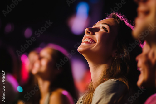 Young european woman looking up at a stage from the audience