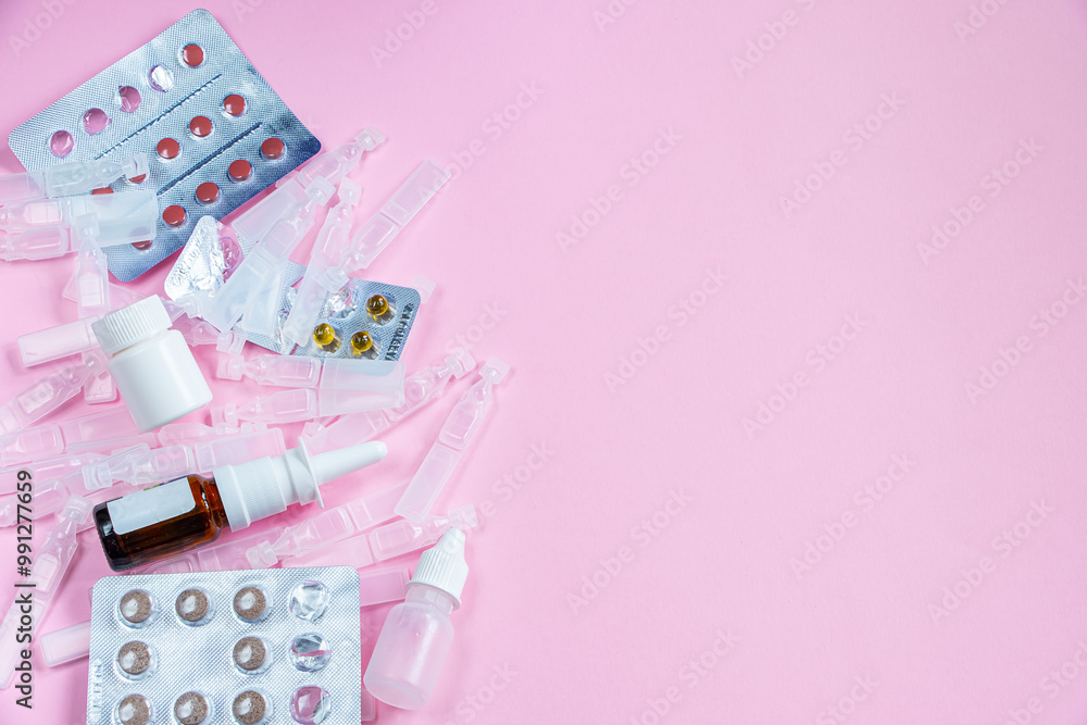 Medications and medical ampoules on pink background. Tablets, drugs and droppers for treatment of diseases. Season of colds and illnesses. Copy space Medications and medical ampoules on pink background. Tablets, drugs and droppers for treatment of diseases. Season of colds and illnesses. Copy space
