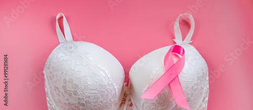 Breast Cancer Awareness Month. Women's bra and pink ribbon on bright background. Health care concept, oncology diagnostics. Cancer Fight Symbol.