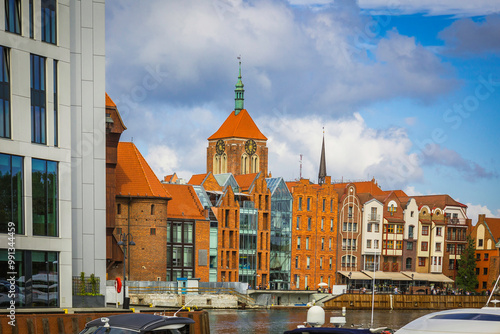 Beautiful city of Gdansk in the margins of the Motlawa river with the touristic boats and coloured buildings photo