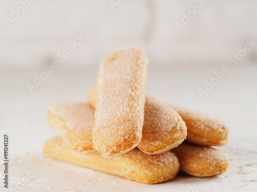 Close up view of ladyfinger biscuit cookie on white concrete background. Italian cookie savoiardi. photo