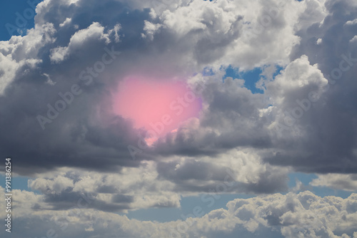 Clouds formed a silhouette of a pink heart in the sky, heavenly heart in the clouds, heart symbol in the sky, silhouette of a heart in the sky photo