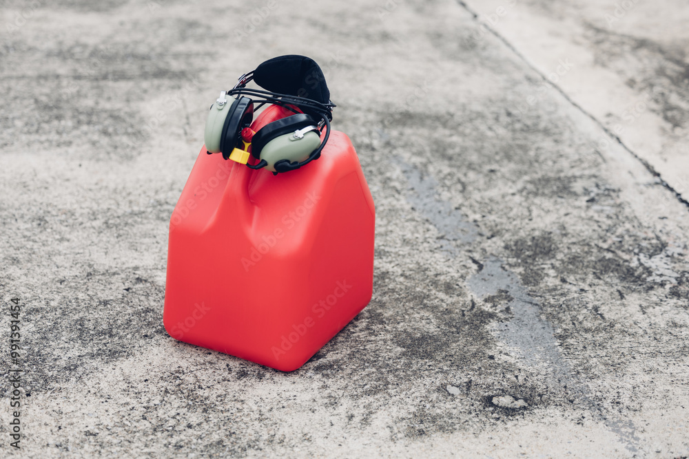Naklejka premium Pilot fueling low-wing propeller driven airplane. Refueling fuel in an aircraft wing. Aviation fuel being into wing tank of a small airplane