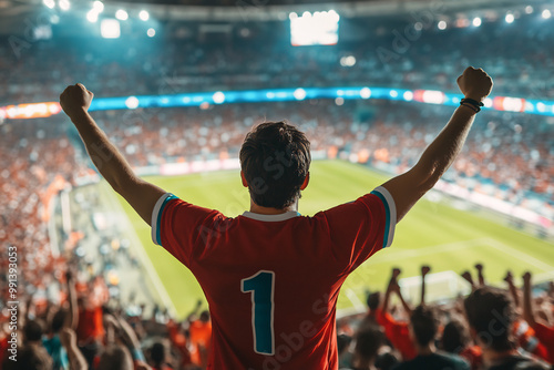 Excited soccer fan cheering with raised arms in a packed stadium, celebrating during a live match