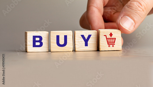Hand Placing Wooden Blocks Spelling buy with Shopping Cart Icon, Stock Image for E-commerce, Online Shopping, Business Marketing, Product Promotions, and Digital Retail Concepts.