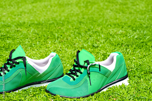 green sneakers on the grass lawn photo