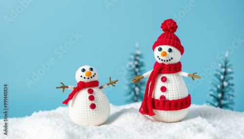 deocrative knitted snowmans on blue background with copy-space