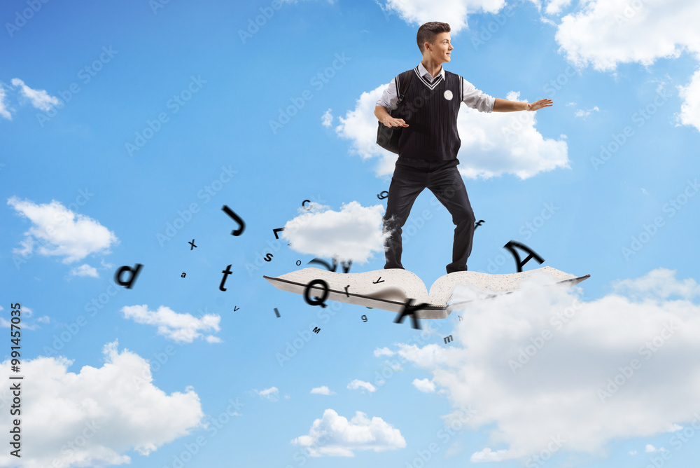 Male teenage student flying on a book Male teenage student flying on a book