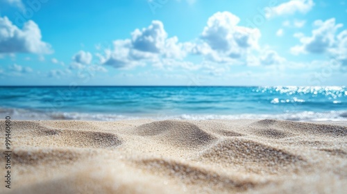 A serene beach scene featuring soft sand, gentle waves, and a clear blue sky, perfect for relaxation and vacation imagery.