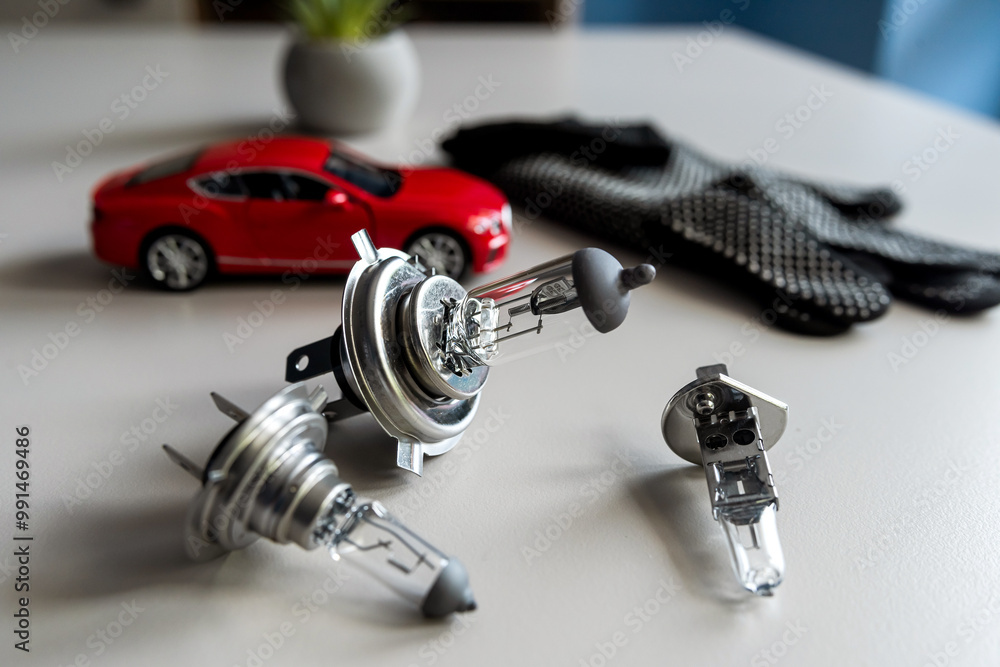 different automotive bulbs h1 h4 h7 with small toy car. Car repair conecpt different automotive bulbs h1 h4 h7 with small toy car. Car repair conecpt