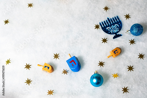 Hanukkah Jewish holiday background with menorah (candelabra) and traditional Dreidel game toy. photo