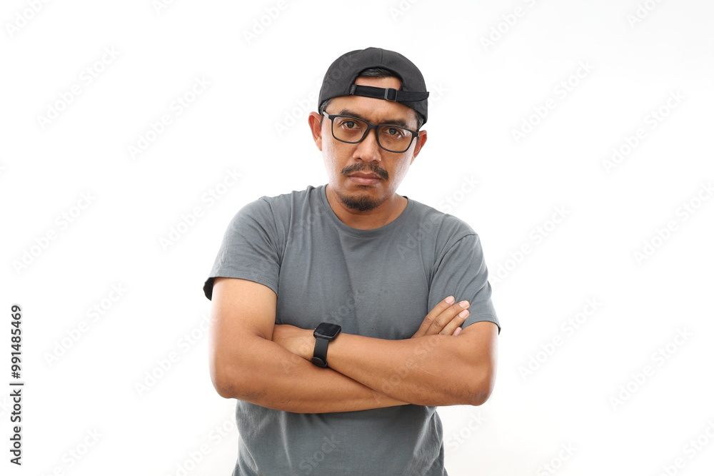 Naklejka premium Asian man with beard wearing casual t-shirt and glasses skeptic and nervous, disapproving expression on face with crossed arms