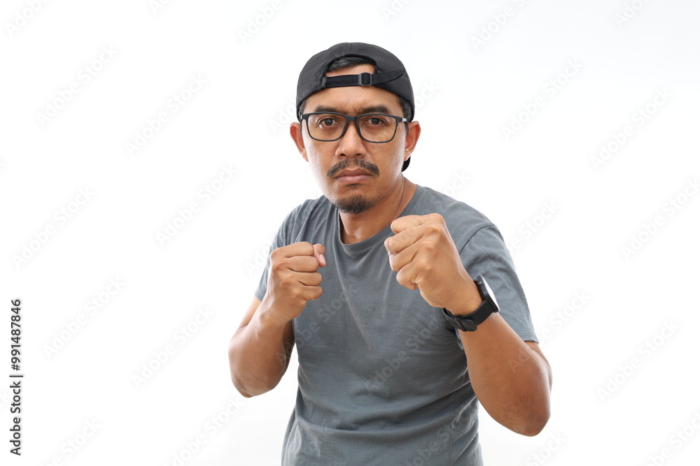 Fototapeta premium Asian man standing over isolated white background Ready to fight with fist defense gesture